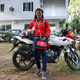 A paramedic staff stands next to a bike inside the premise of Gokada bike company in Lagos